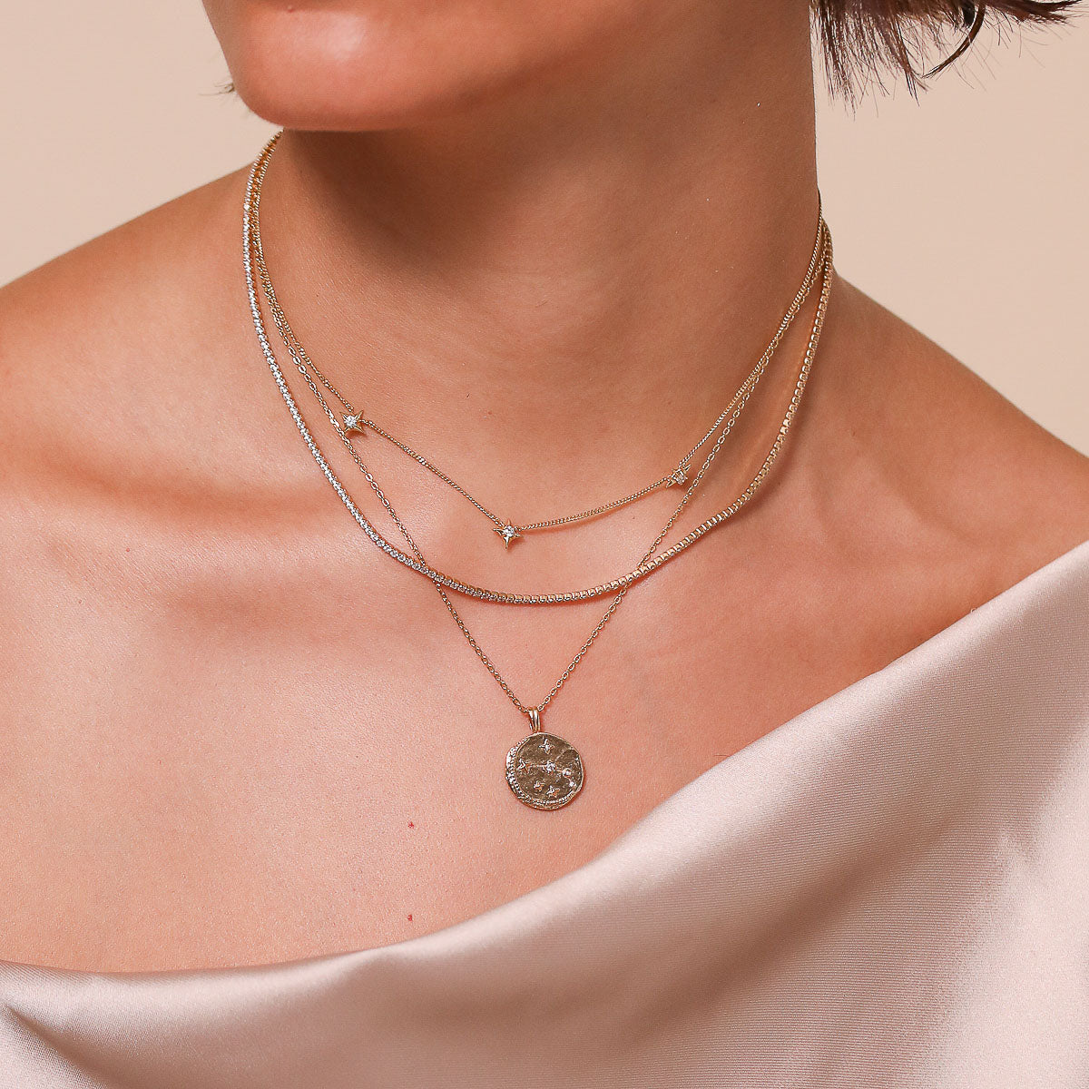 Aries Zodiac Pendant Necklace in Gold worn layered with necklaces